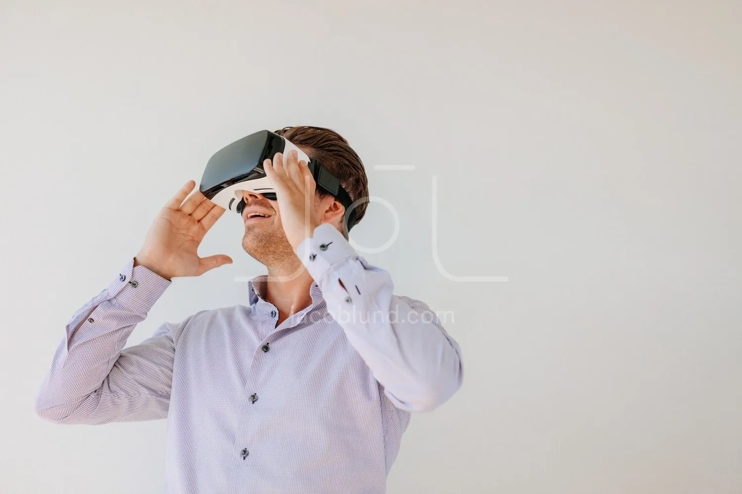 Caucasian male model wearing VR goggles