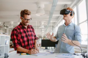 Developers testing virtual reality glasses in office